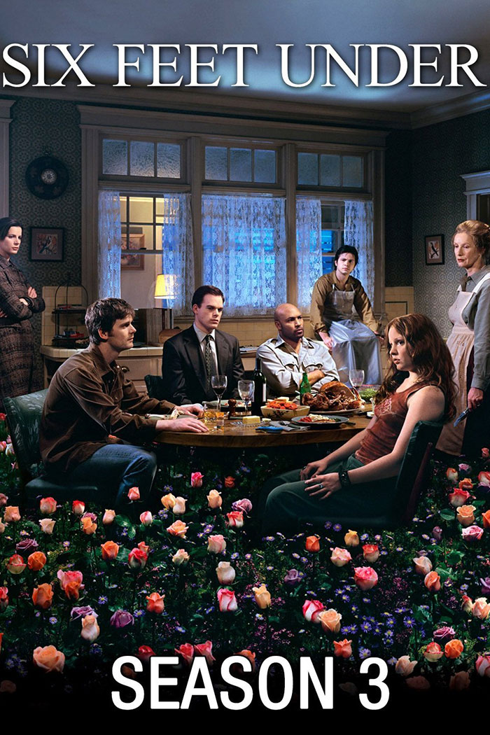 "Cast of Six Feet Under gathered around a dinner table surrounded by flowers, promoting an HBO TV show."