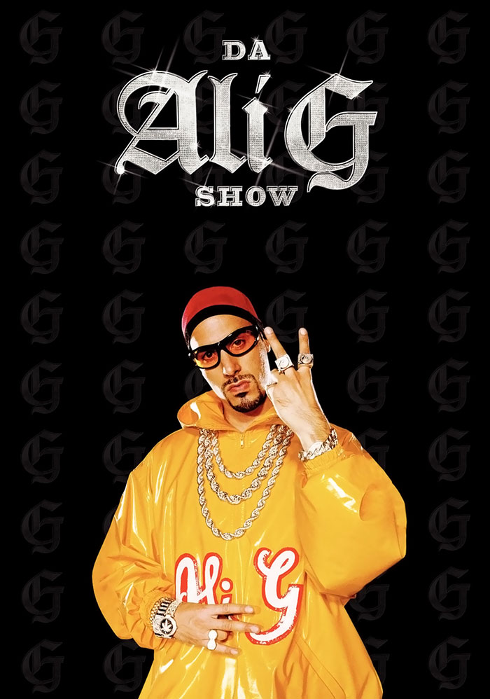 "Ali G in a yellow jacket and sunglasses from popular HBO TV show with black background."