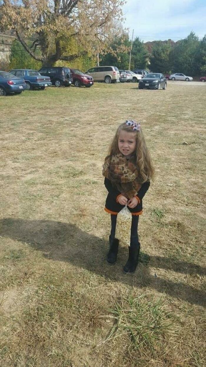 Young Girl Posing With A Bag Of Popcorn