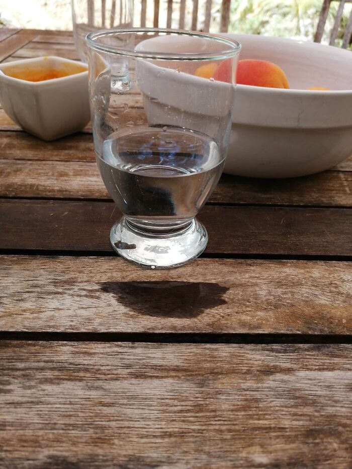 The Water Spilled In A Way So It Looks Like The Glass Is Levitating