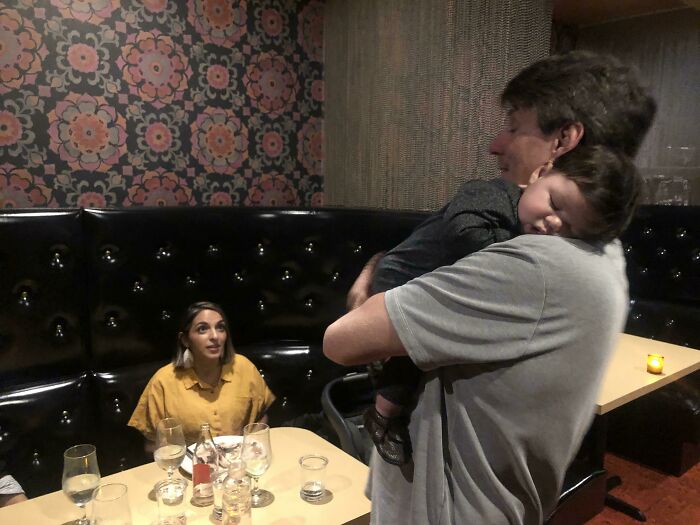 My Wife And I Couldn’t Get Our Newborn Baby To Stop Crying At The Restaurant, So We Embarrassingly Started To Pack Up To Go Home When The Couple Sitting Next To Us Offered To Hold Him So We Could Enjoy A Night Out. Our Baby Slept On This Kind Strangers Shoulder The Entire Evening!