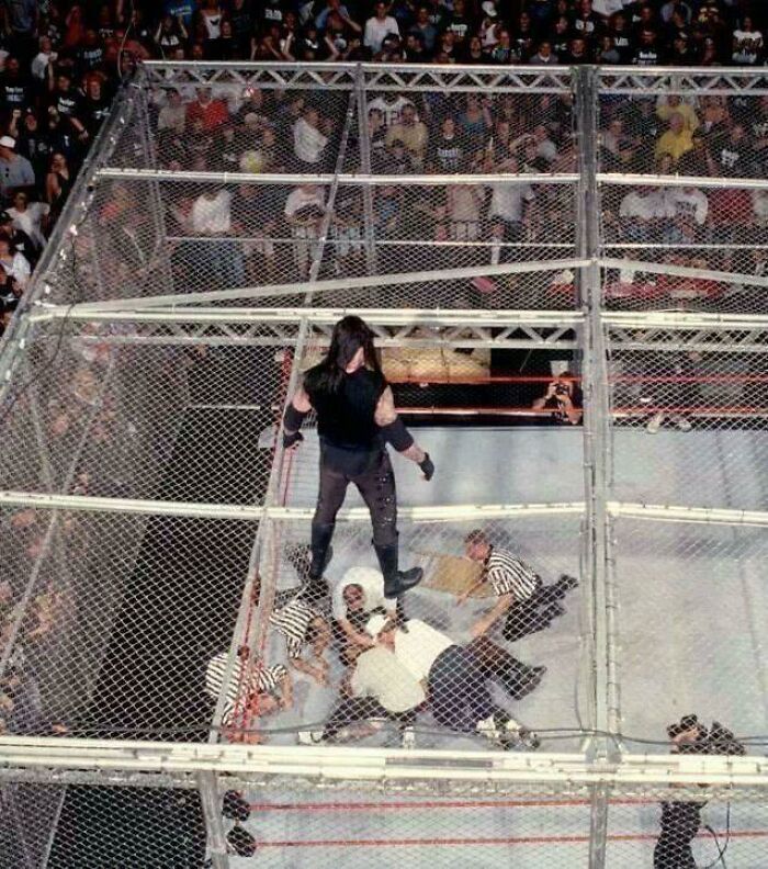 The Undertaker Looks Down At Medical Staff Checking On Mankind After He Fell, Unscripted, Through The Top Of Hell In A Cell Into The Ring 16ft Below. June 28, 1998 