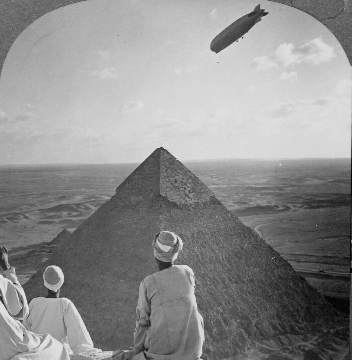 Egyptian Men Watch As The Graf Zeppelin Floats Over The Great Pyramids Of Giza, Egypt, While Atop The Great Pyramid Of Khufu. 1931