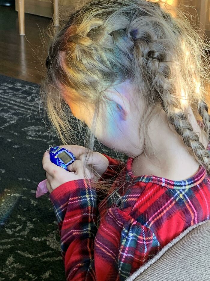 My Daughter. Playing With Her New Tamagotchi