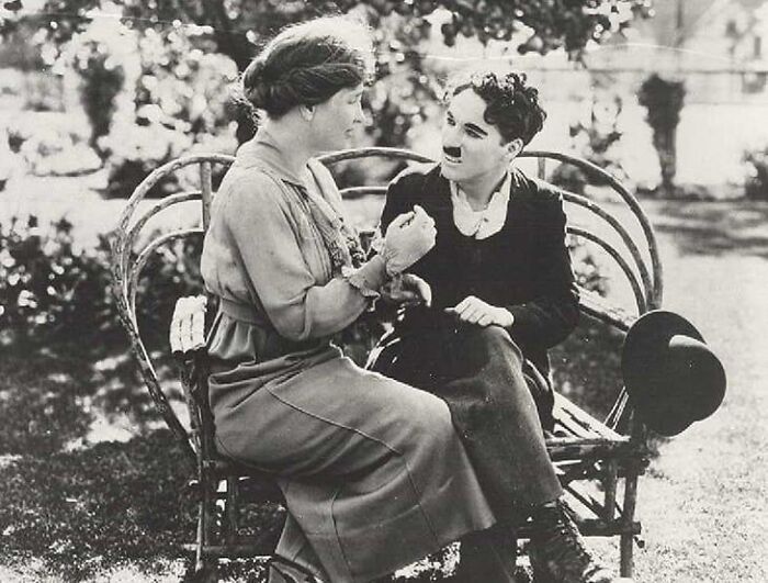 Helen Keller Teaching Charlie Chaplin The Manual Alphabet. The Two First Met In 1918 Where Keller Would Communicate With Chaplin By Reading His Lips With Her Hand, Feeling The Movements Of His Jaw And Vibrations Of The Throat