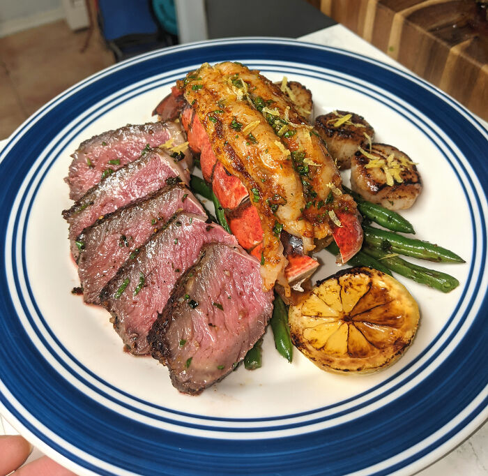 Pan-Seared Steak And Scallops, Baked Lobster Basted With Compound Butter, And Garlic Green Beans