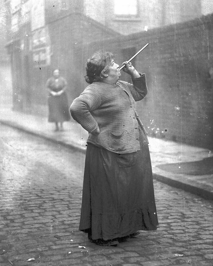 A Knocker-Upper Was Someone Whose Purpose Was To Wake People Up During A Time When Alarm Clocks Were Expensive And Not Very Reliable. They Earned About Six Pence A Week Using A Pea Shooter To Shoot Dried Peas At The Windows Of Sleeping Workers In East London, 1930s. She Would Not Leave A Window Until She Was Sure That The Workers Had Woken Up