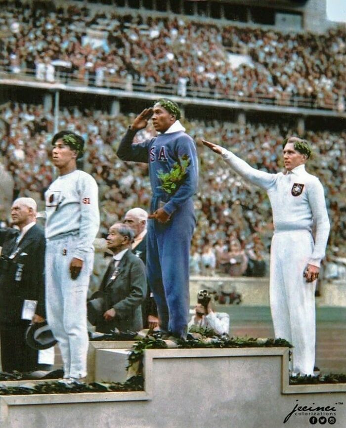 Jesse Owens, American Track And Field Athlete And Four-Time Gold Medalist, Salutes During The Presentation Of His Gold Medal For The Long Jump, After Defeating Nazi Germany’s Luz Long During The 1936 Summer Olympics In Berlin, Germany.