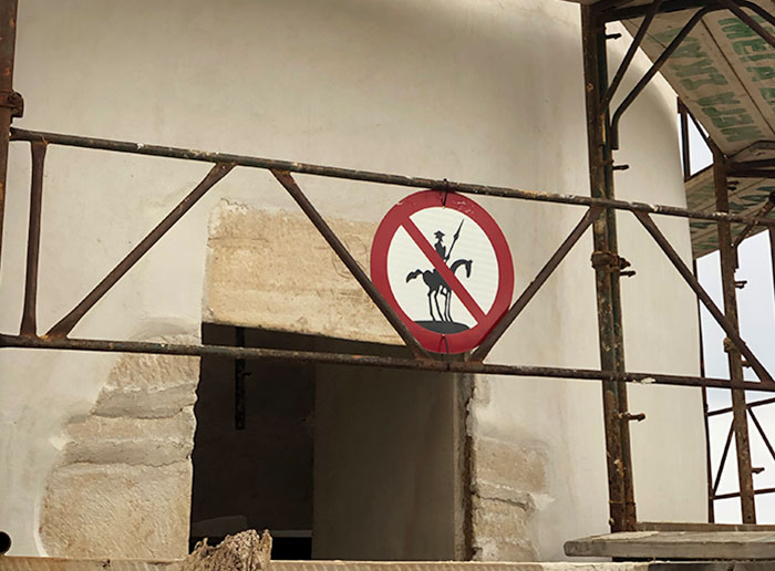 A Sign At A Windmill Restoration Site In Mykonos, Greece