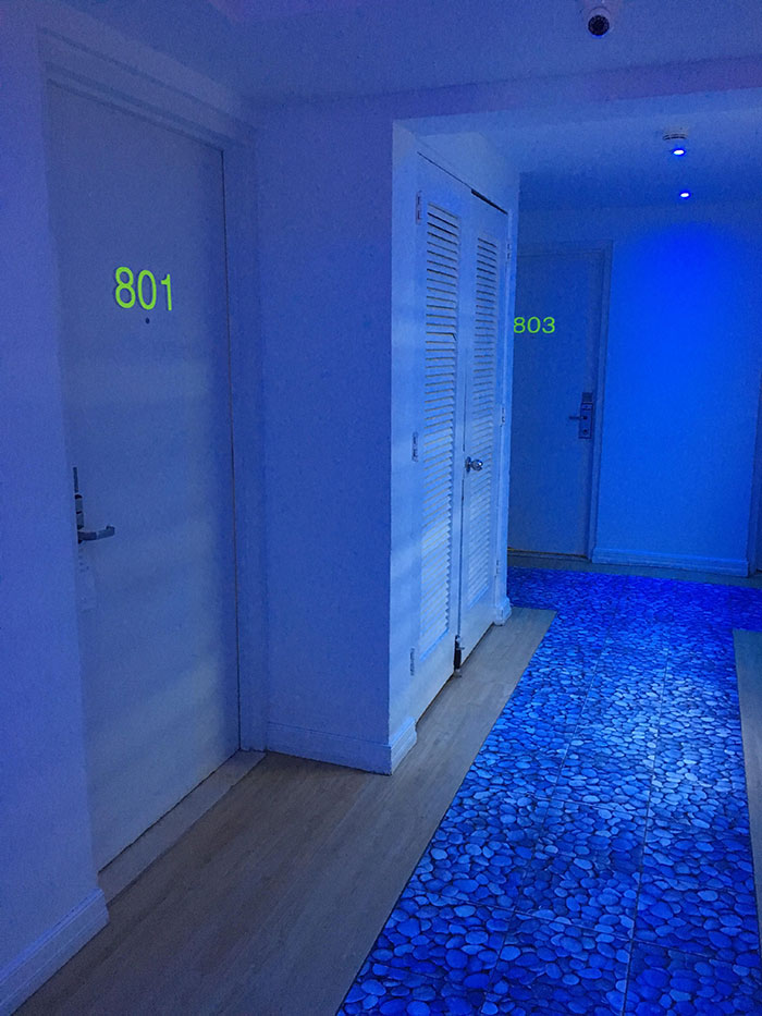 Hotel In San Juan, With Black Lights In The Hallways And Neon Room Numbers On The Doors
