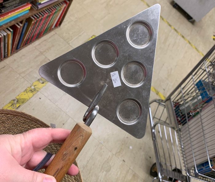 Metal Triangle Shaped Hand Tool With An Offset Wooden Handle. Five Shallow Circle Indents On The Surface. Similar To A Trowel. Found In The Kitchen Section Of A Thrift Store, But Could Have Been Misplaced