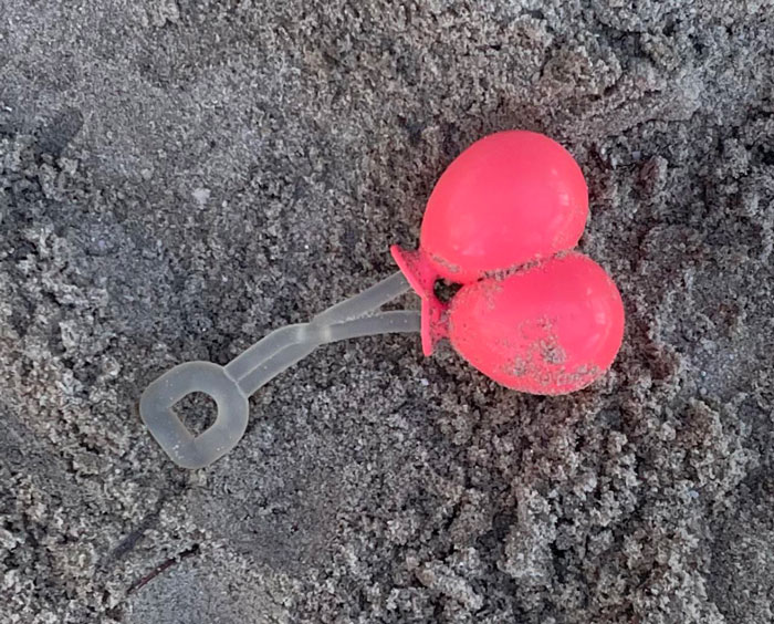 Red And Clear Rubber Toy Like Thing Found In A Playground