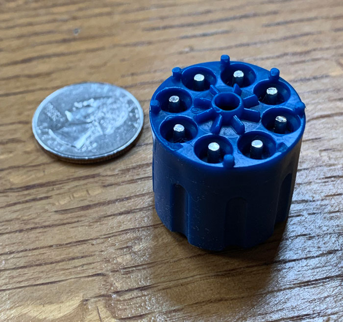 What’s This Hard Plastic 8 Chamber Unit With Rigid Metal Non-Moving Pins? Some Kind Of Revolver Cylinder?