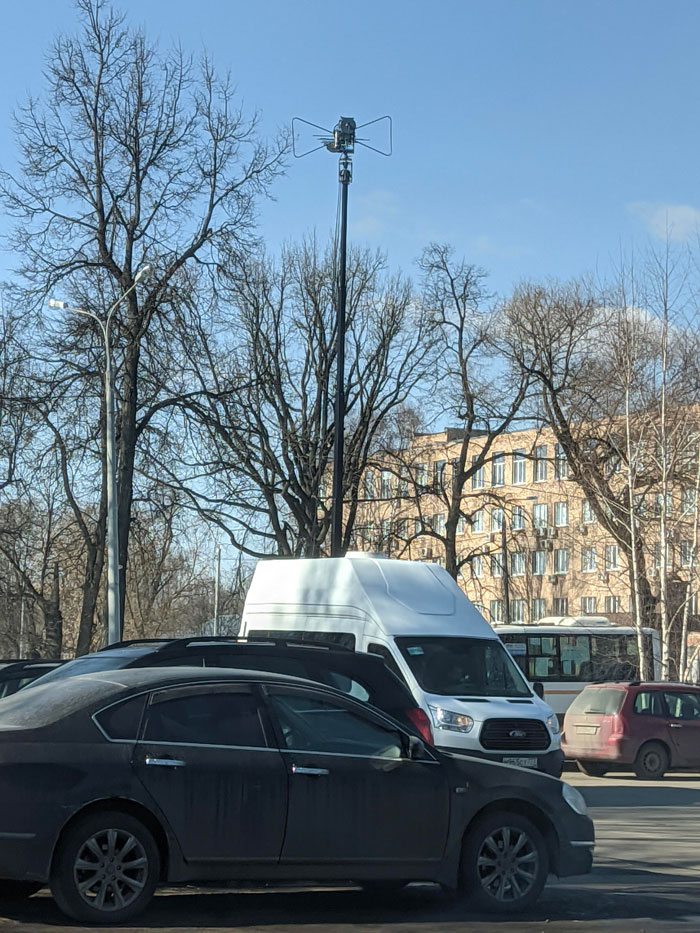 Minivan With Telescopic Antenna On Top. It Appears That Antenna Is Tracking Something