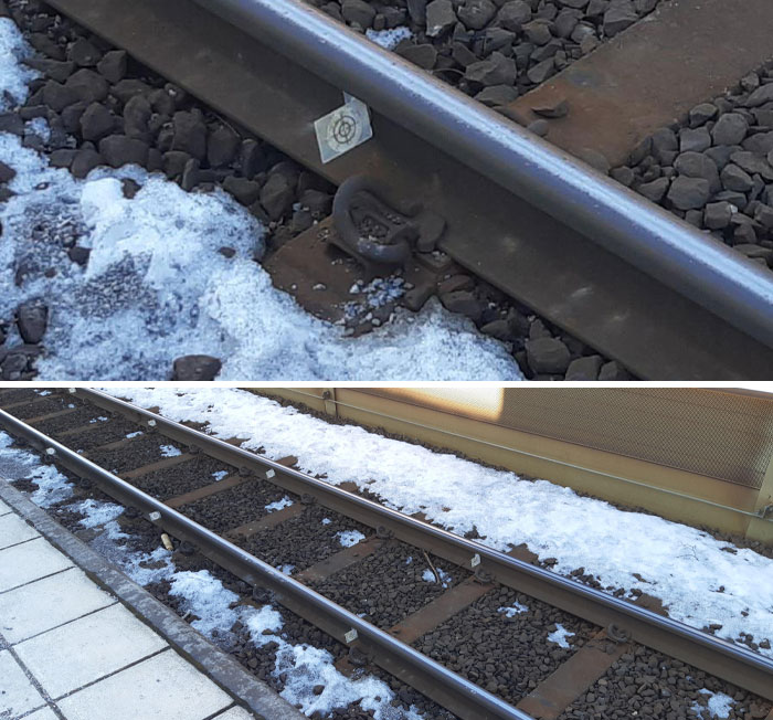 What Are These Successive White Target Markers Attached To The Train Tracks? They Have A Tiny Through Hole In The Middle And Are On Both Rails At The Train Stop