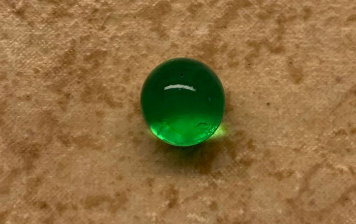 Beautiful Transparent Green And Sphere, But Not A Marble. Found Outside In North Texas. It Has Shrunk In The Last 2 Days. When Found It Was The Size Of A Marble, Now The Size Of A Pea, But Still Perfectly Sphere
