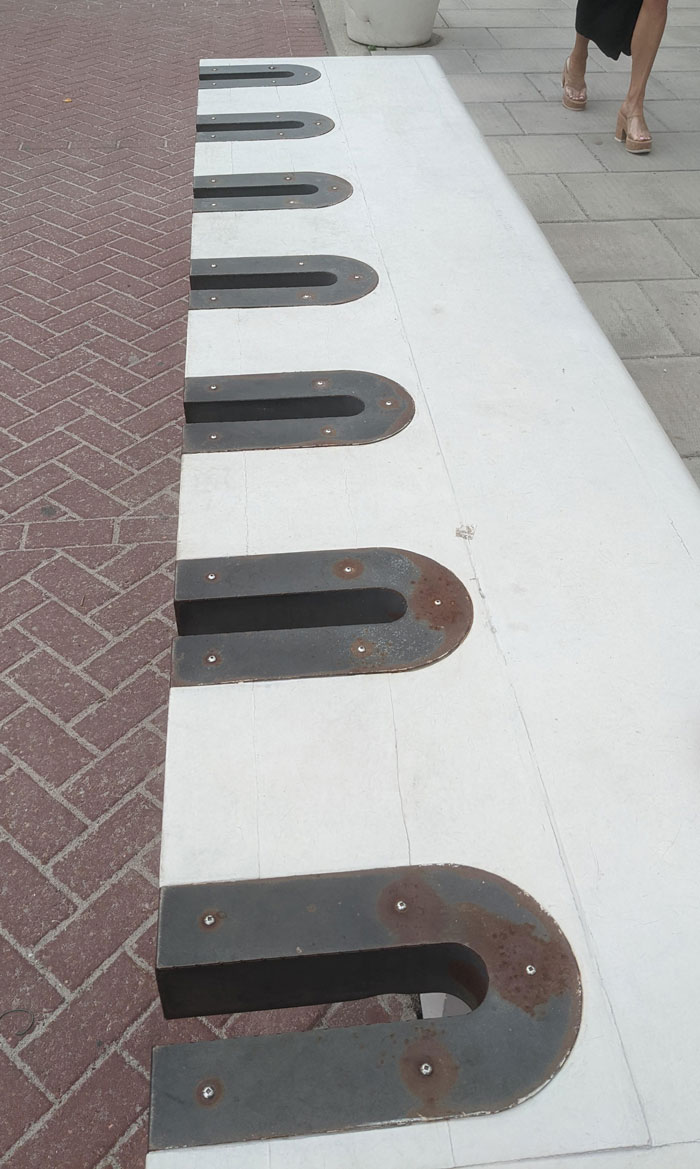 Park Bench With Weird Cutouts. Don't Think It's For Bikes, You'd Need A Really Long Chain To Wrap All The Way Around