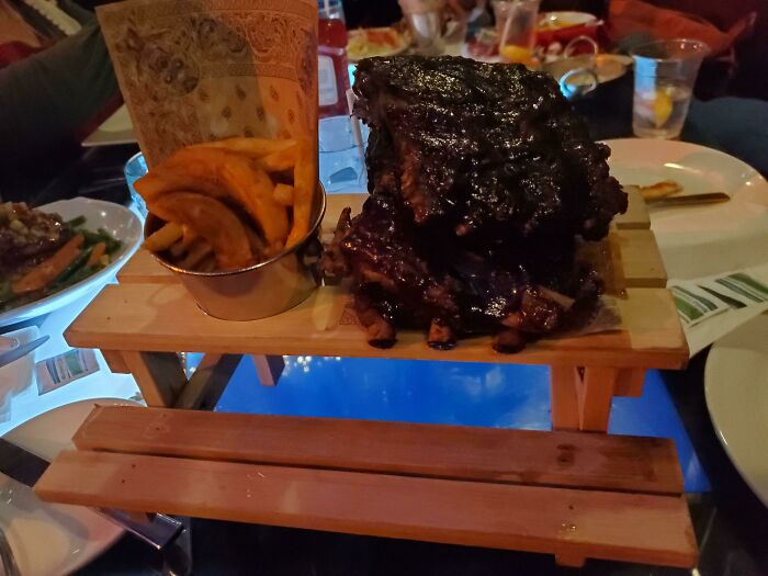 My Food Was Served On Top Of A Mini Picnic Table, Placed On A Table That Was Actually A TV