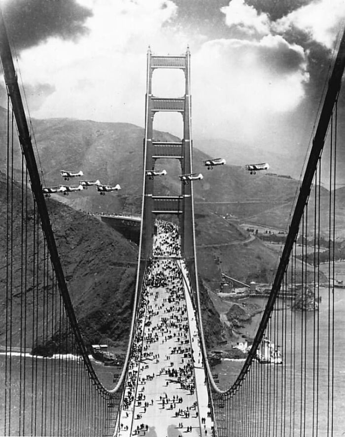 Planes Fly Between The Towers And Pedestrians Cross As Part Of The Celebration Of The Opening Of The Golden Gate Bridge In May Of 1937.