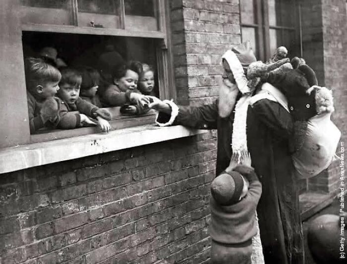 This 1931 Photograph Captures The Spirit Of The Season As Santa Delivers Presents To The Children Of An Adoption Home In London.