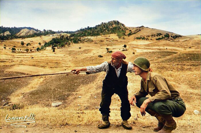 Robert Capa Sicilian Peasant Telling An American Officer Which Way The Germans Had Gone. Near Troina. Italy. August, 1943.