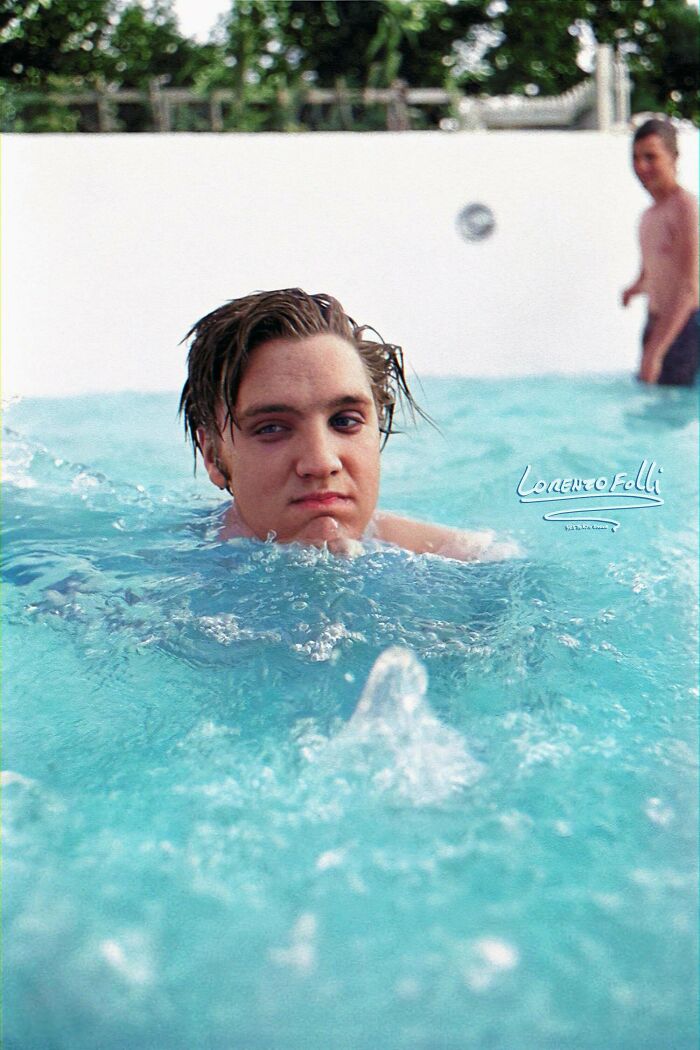 American Musician (And Actor) Elvis Presley (1935 - 1977) Swims In The Pool Of His Family's Recently Purchased House, Memphis, Tennessee, On July 4, 1956.