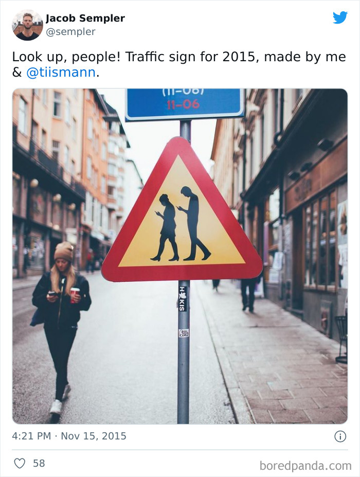A Road Sign Warns Drivers That They May Encounter Pedestrians Who Are Deeply Absorbed In Their Smartphones, In Stockholm, Sweden