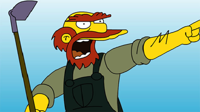The Simpsons character Groundskeeper Willie is holding a grub hoe and shouting