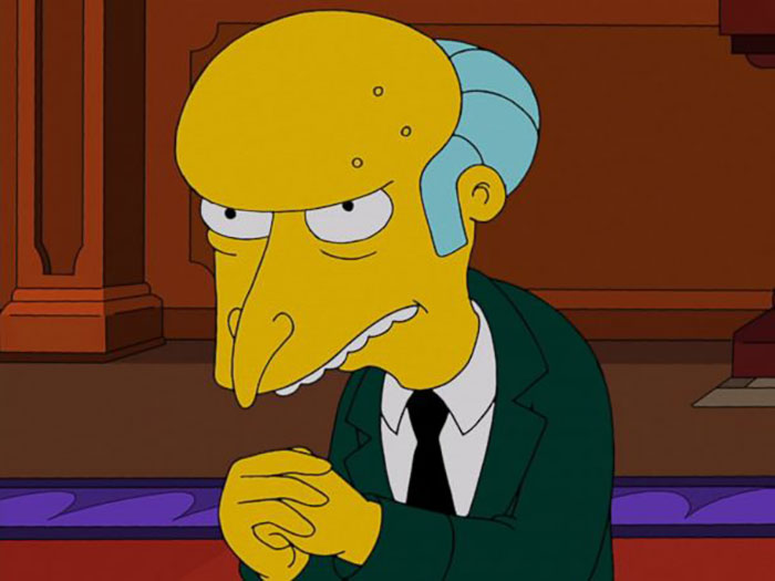 The Simpsons character Mr. Burns is looking with folded hands