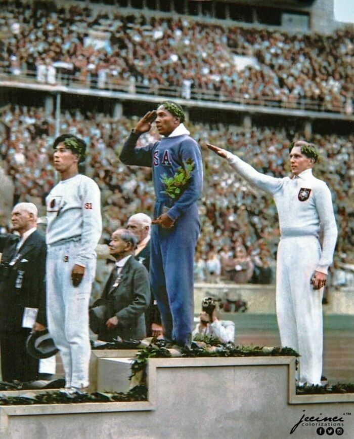 Jesse Owens, American Track And Field Athlete And Four-Time Gold Medalist, Salutes During The Presentation Of His Gold Medal For The Long Jump, After Defeating Nazi Germany’s Luz Long During The 1936 Summer Olympics In Berlin, Germany