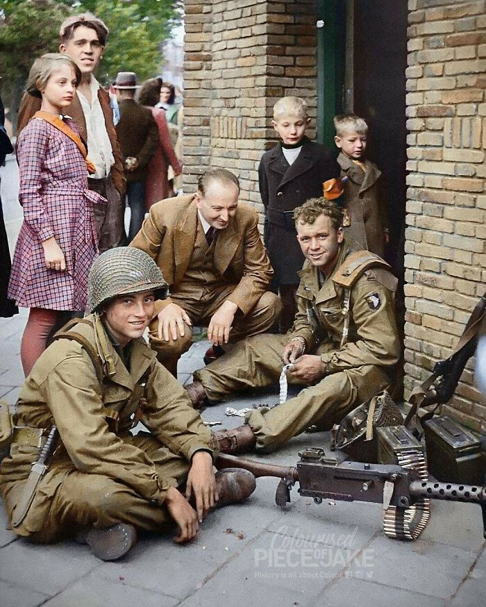 Two Men Of The 506th Parachute Infantry Regiment Photographed Among Citizens Of Eindhoven, The Netherlands While Restocking Ammunition Of Their M1919a6 Browning Machine Gun On The 18 September 1944