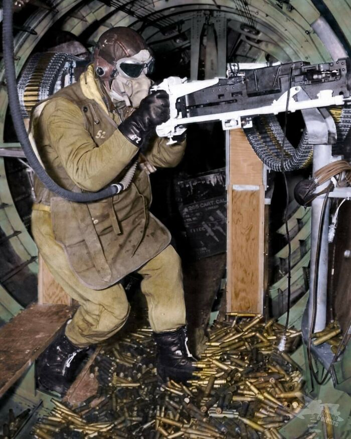 A Waist Gunner Of A B-17 Flying Fortress Aircraft Holding On To A Mounted .50 Caliber Machine Gun. Photograph Taken In The 1940s During World War II