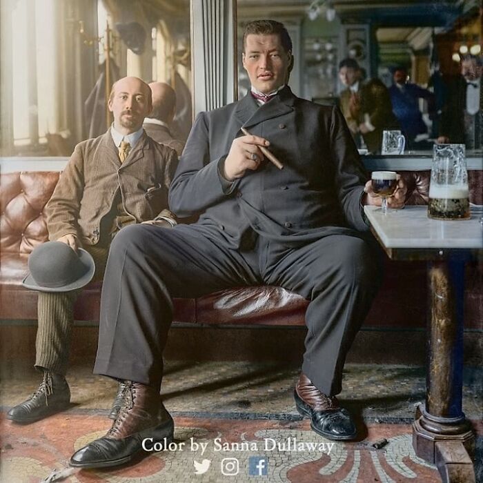 A Giant, Believed To Be Adam Rainer, Sitting In A Tavern Drinking A Beer In The 1900s. Adam Rainer Is The Only Person In Medical History To Be Considered Both A Dwarf (Measuring At Under 4ft 10in (1.47m) At The Age Of 18) And A Giant (Measuring At 7ft 8in (2.34m) At The Time Of His Death In 1950) During His Life
