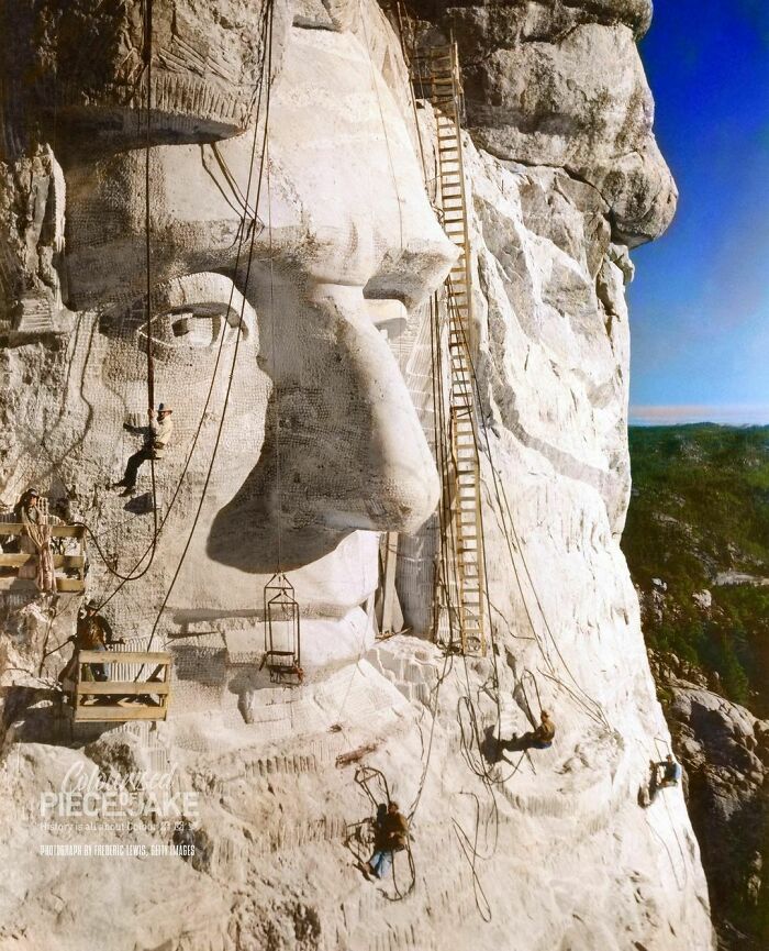 Gutzon Borglum, The Architect Of Mount Rushmore, Hanging Below The Eye Of Abraham Lincoln As The Crew Works On The Carving Of Lincoln's Head Into The Mountain. Photograph Taken In 1935, 8 Years Into The Construction Of Mount Rushmore