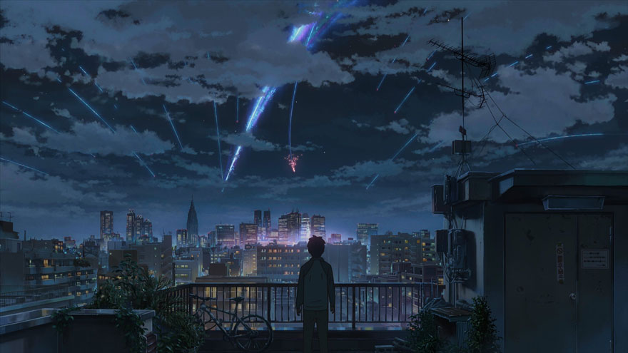 Night scene - a young man standing on the roof and looking at the cityscape