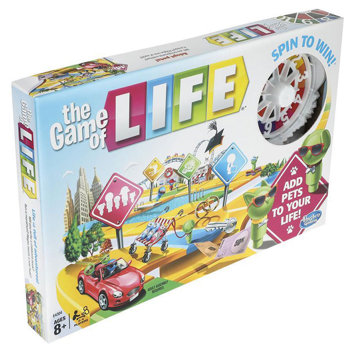 The Game of Life board game box featuring colorful road signs, a red car, and game pieces for a fun night in.
