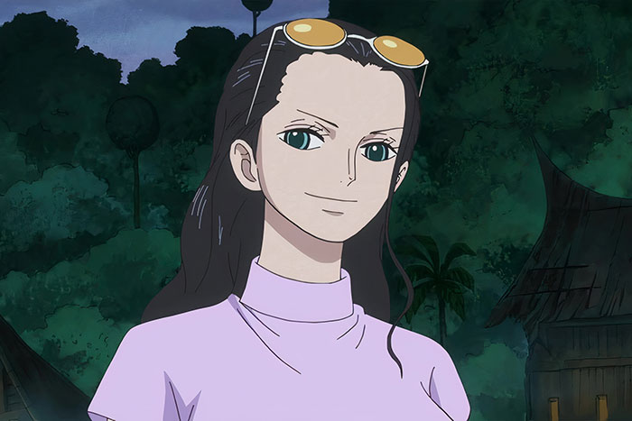 Female anime character smiling in a forest setting, wearing sunglasses and a purple top.