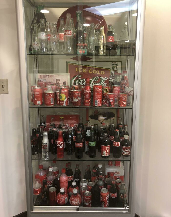 The Waiting Room Of This Doctor’s Office Has Some Magazines, Small Plants, And One Large Collection Of Coca-Cola Bottles And Cans From Around The World