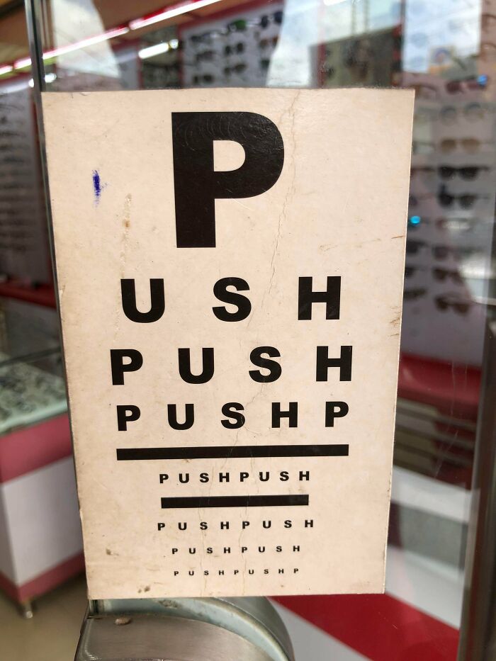 A Push/Pull Sign On The Door Of A Glasses Shop