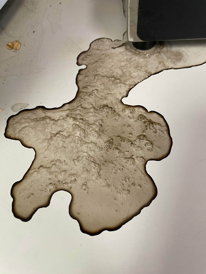 Was Told To Post This Dried Coffee Puddle From Last Night Here. Looks Like A Fantasy Map. Also Looks Like It’s Lumpy Or Has Elevation But It’s Completely Flat And Smooth