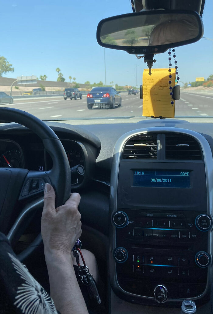 Mom Using Her Car Phone Holder For Written Driving Directions