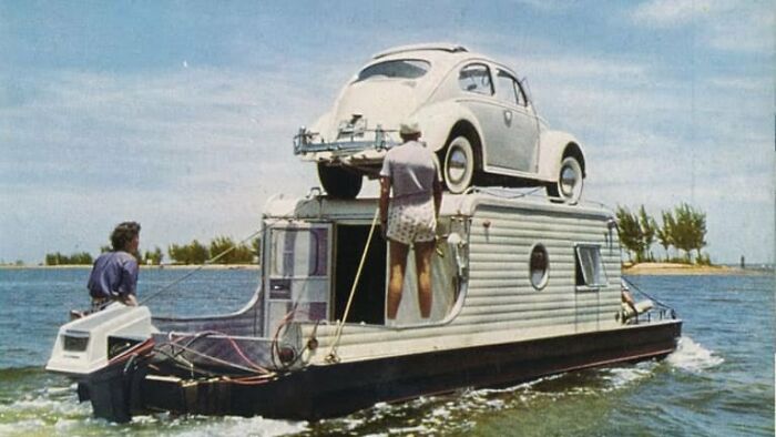 The Classic Aqua-Trail “Terra Marina” Was In Business From 1956-1964+ In Many Sizes From 24'-36' And Widths Of 8' And 10' Wide. These Were Fully Amphibious Travel Trailers As The Wheels Were Retractable Into The Hull. Notice The Steering Helm Behind Lady In Red. Operator Would Stand On That Bench