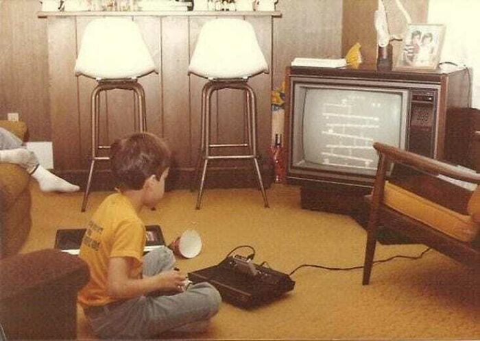 A Boy Is Playing Atari Home Video Games In 1982