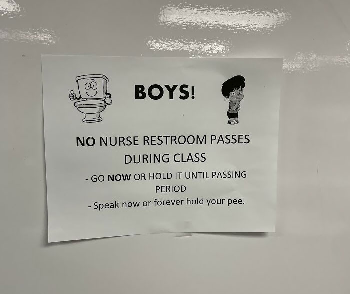 In A Classroom. Boys Bathroom Also Has Multiple Signs