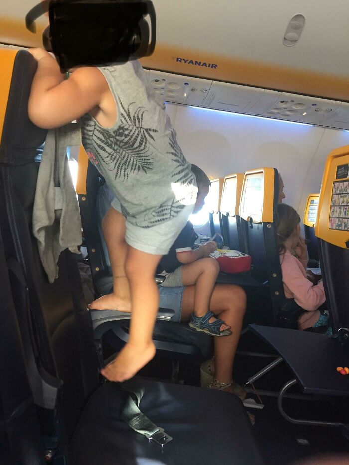 Spotted This Kid Next To Me Jumping And Climbing On His Seat While The Plane Was Landing. Parents Please