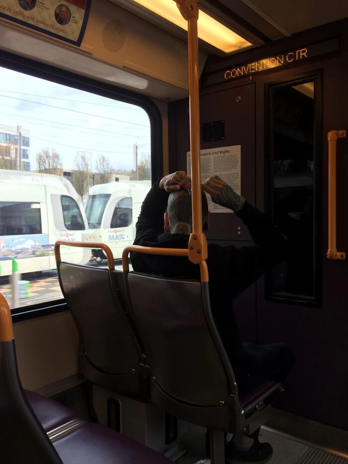 Guy Shaving His Head On Public Transit