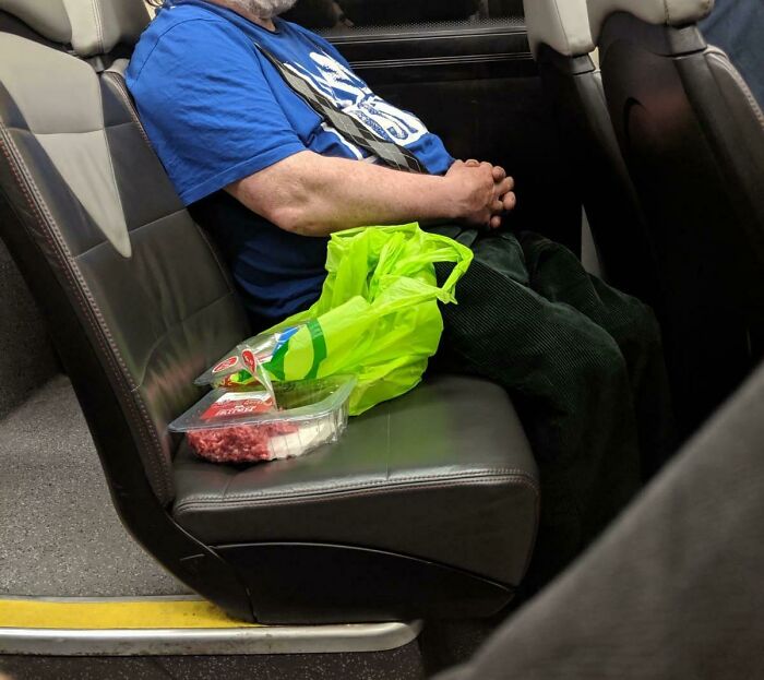 A Friend Shared This Photo Of A Guy On His Bus Eating A Pack Of Raw Mince Meat And Pork Chops Straight Out Of The Packet