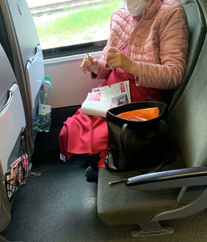 Elderly Woman Clipping Her Nails In Public Transport