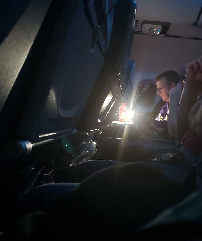 This Guy Using His Phone's Light To Play Crossword Puzzles During The Majority Of My 5-Hour Flight Home