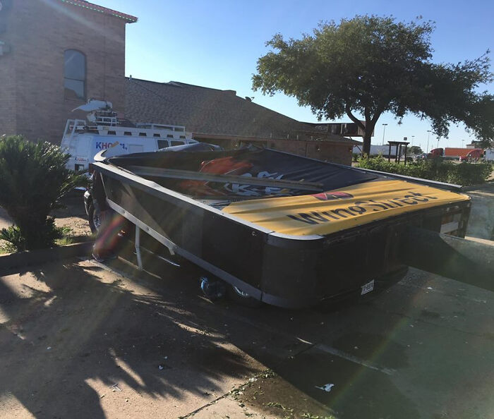 Pizza Hut Sign Blown Over Onto Truck In Bad Weather
